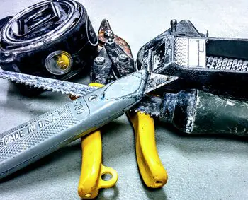 Various drywall tools including a utility knife, keyhole saw, tin-snips, measuring tape, and chalk-box