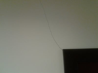 Drywall crack above door frame because of settling