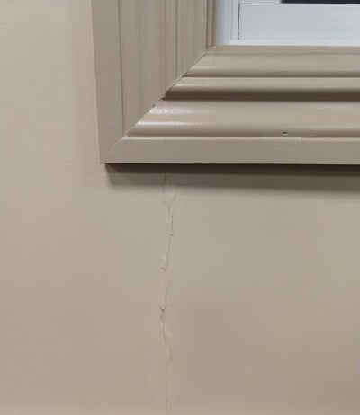 Drywall crack above long opening where beam distributes weight