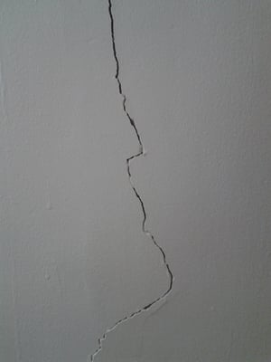 Picture of a large crack in a plaster wall