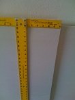 Measure drywall and place T-square on cut line