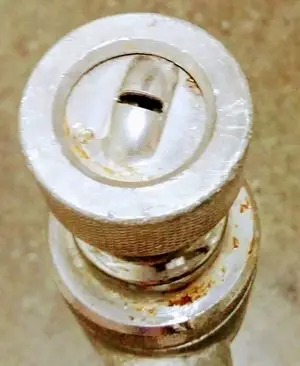 Photo of the tip of a spray nozzle that is used to apply splatter knockdown texture