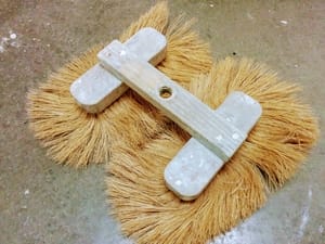 Top view of a double crows foot stomp brush used for drywall texture
